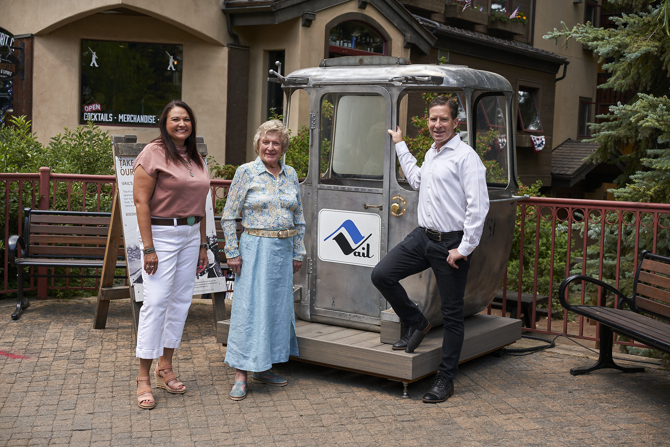 John Tyler with Lindsay Bruce and Carroll Tyler beside a vintage Vail gondola car in Vail Village